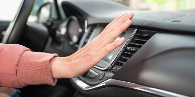 James Wood Buick GMC in Decatur TX close up of a hand in front of vent checking ac tempterature